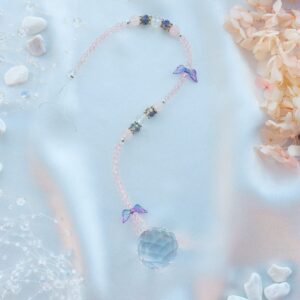 Keskmine päikesepüüdja roosa kvartsi ja violetsete tiibadega